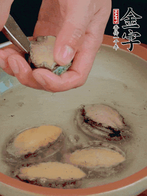 鮑魚加鹽、清水浸泡，用勺子挖出鮑魚肉。